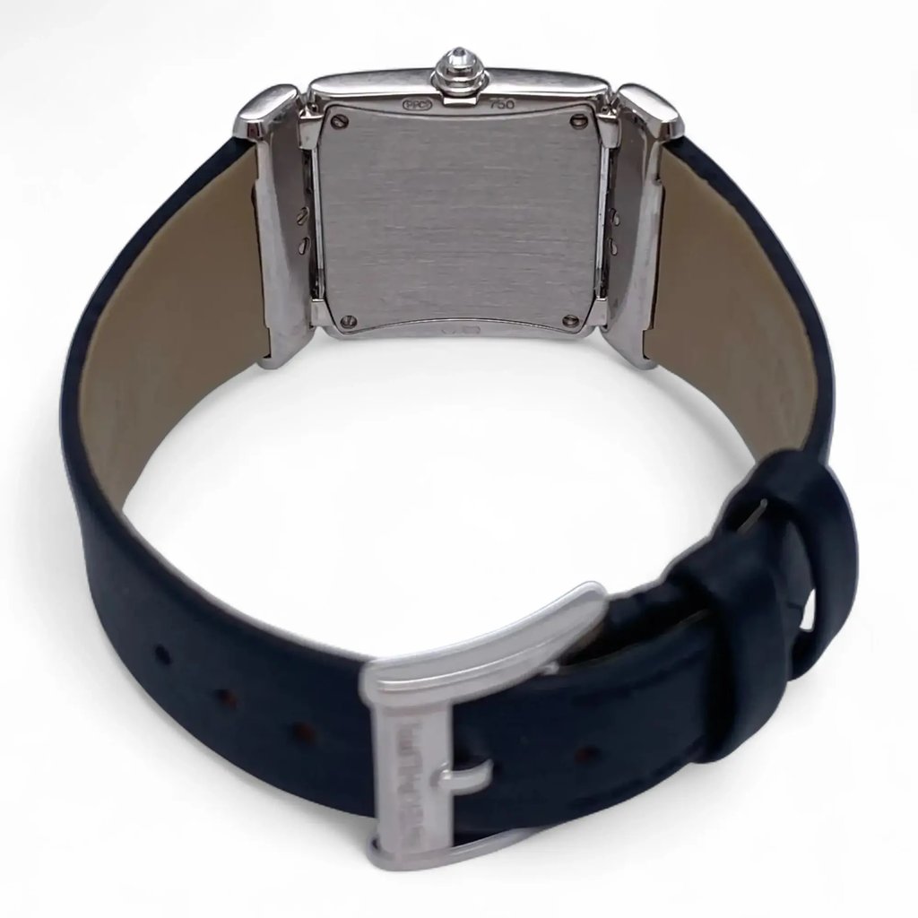 An image of a pre-owned Patek Philippe women's wristwatch viewed from the back. The angle shows the back case prominently, with the watch positioned upright. The leather strap is partially visible, with the buckle in the foreground, and the entire watch is captured at a close distance, highlighting the details of the watch's rear and strap.