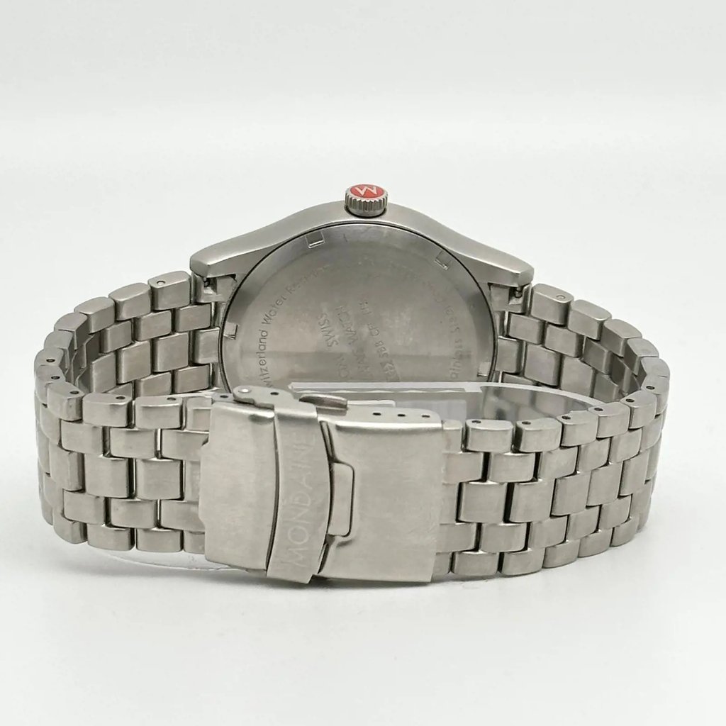 An image of a Wristwatch by Mondaine. This Pre Owned item is designed for Men, featuring a Casual,Classic,Dress/Formal style. It has a Quartz movement and an Analog display with a White dial color. The indices include 12-Hour Dial,Stick Indexes. The band is made of Stainless Steel and the case is made of Stainless Steel. The watch has a Round shape with a case size of 41 mm and a case thickness of 10 mm.