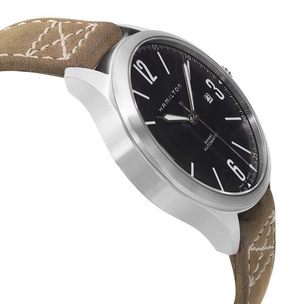 An image of a wristwatch taken from a side profile view, opposite the crown. The watch features a sleek silver case and a black dial with bold white numerals and hands. The watch is displayed at a slight angle, showcasing its thickness and the texture of the brown leather strap with white stitching. The shot is taken from a close distance, highlighting the watch's design details.