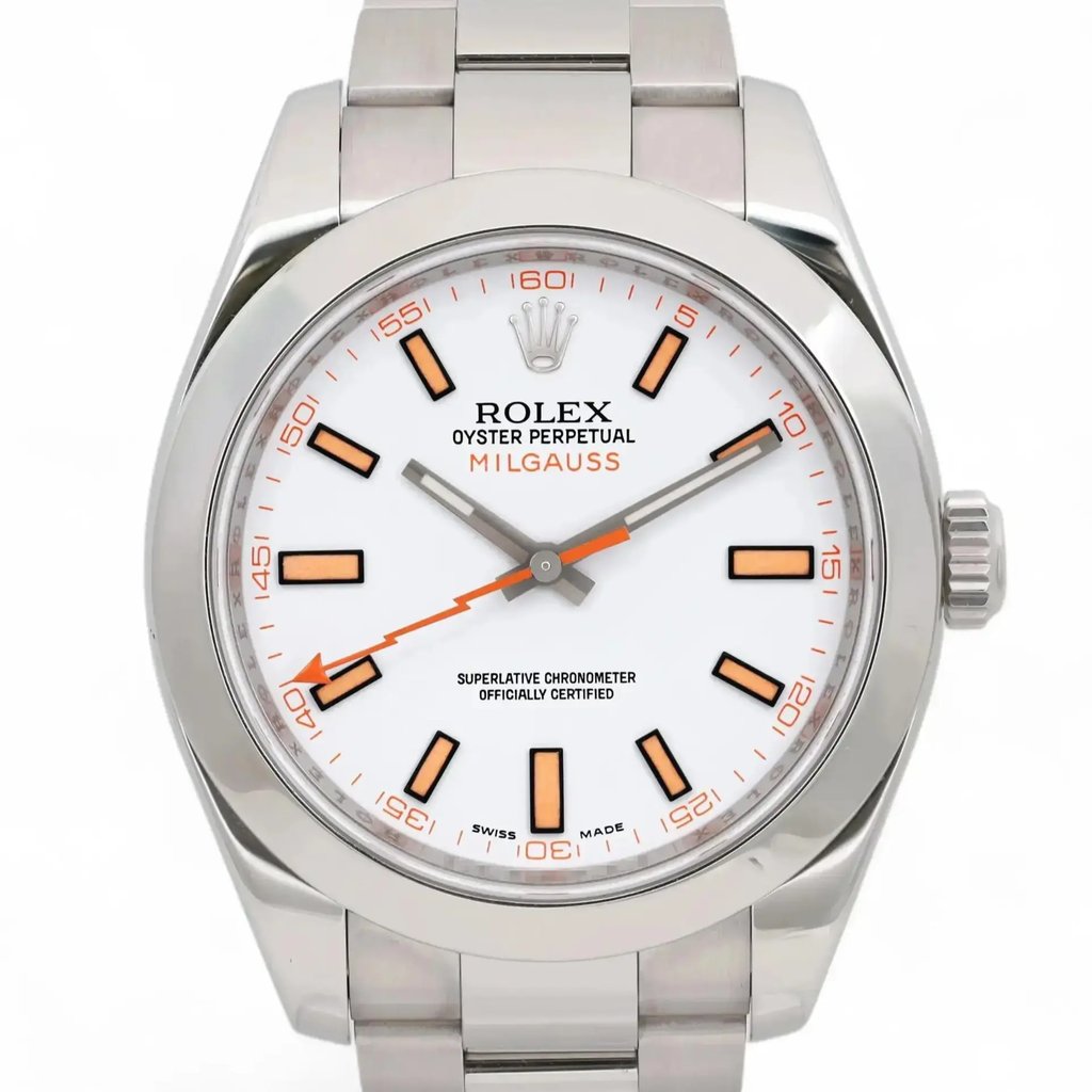 An image of a pre-owned men's Rolex Milgauss wristwatch. The watch is shown from a front-facing angle, capturing the entire face and part of the stainless steel bracelet. The watch face is white with orange and black hour markers, featuring luminous hands. The image is taken at a close distance, showcasing the detailed design and branding on the dial.