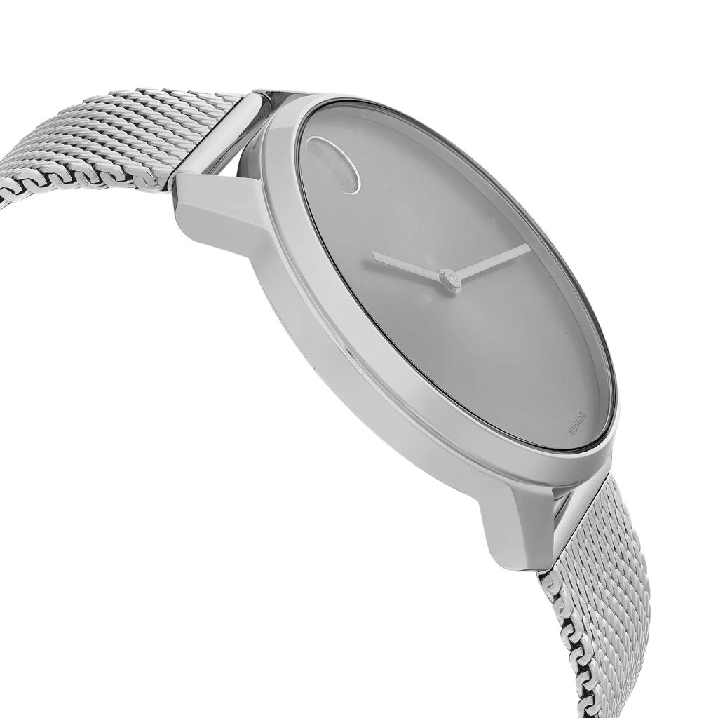 An image of a wristwatch shown from a side profile view, opposite the crown. The watch features a sleek and minimalist design with a metallic mesh strap. The angle highlights the watch's thin case and smooth, uncluttered dial. The distance allows for a clear view of the watch's elegant contours and craftsmanship.