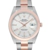 An image of a close-up front view of an unworn Rolex Oyster Perpetual Datejust wristwatch for men. The watch has a round shape and features a silver sunburst dial with rose gold bezel, Stick indexes and luminous hands. The date indicator is visible at the 3 o'clock position. It has a two-tone band made of rose gold and stainless steel, and the case is also stainless steel. The watch is positioned straight on and fills the frame, showcasing its luxury and dress/formal style.