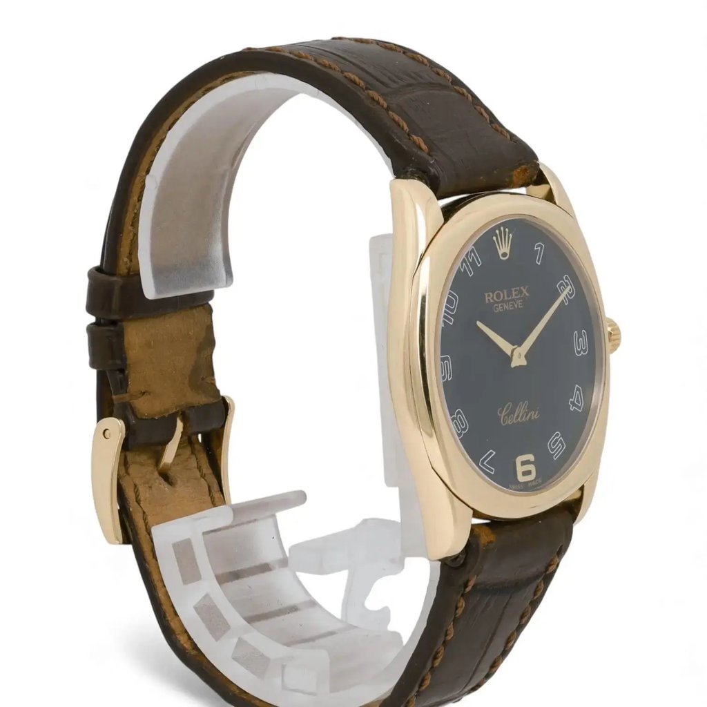 An image of a pre-owned men's Rolex wristwatch, positioned at a slight angle to the right. The watch features a dark brown leather strap and a rose gold case. The dial is black with white numerals and hands, and the Rolex logo is visible at the top. The watch is displayed at a close distance, showcasing its elegant design and craftsmanship.