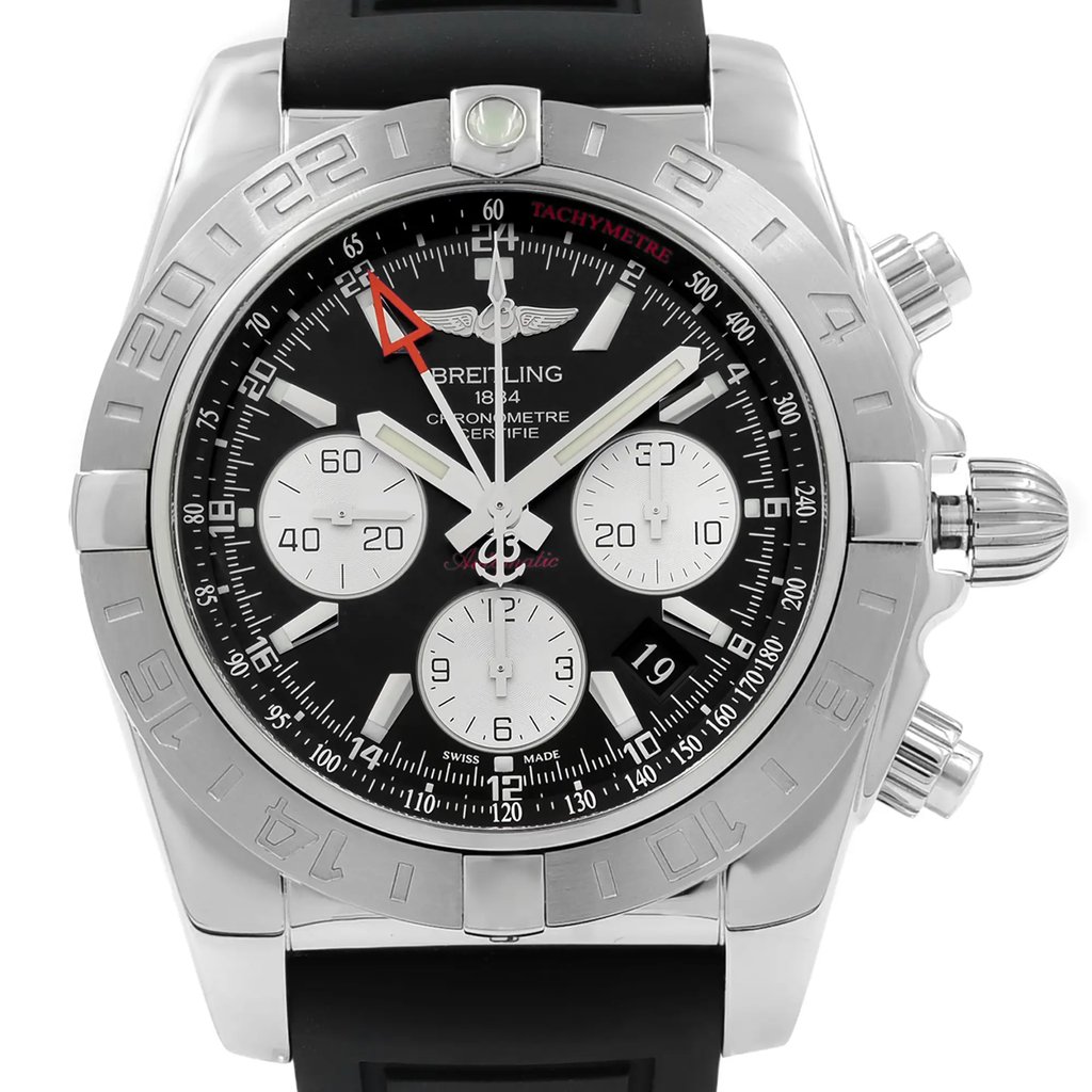 An image of a pre-owned Breitling men's wristwatch in good condition, shown in a front close-up view highlighting the watch face. The watch features a round stainless steel case, a black dial with stick indices and a seconds hand, and a gray bezel with a tachymeter on the inner bezel ring. The style is luxury with a rubber band, and the dial includes three subdials. The angle of the shot is head-on, providing a clear view of the watch details, and the distance is close enough to see the textures and inscriptions on the dial and bezel. The watch shows light signs of wear or scratches.