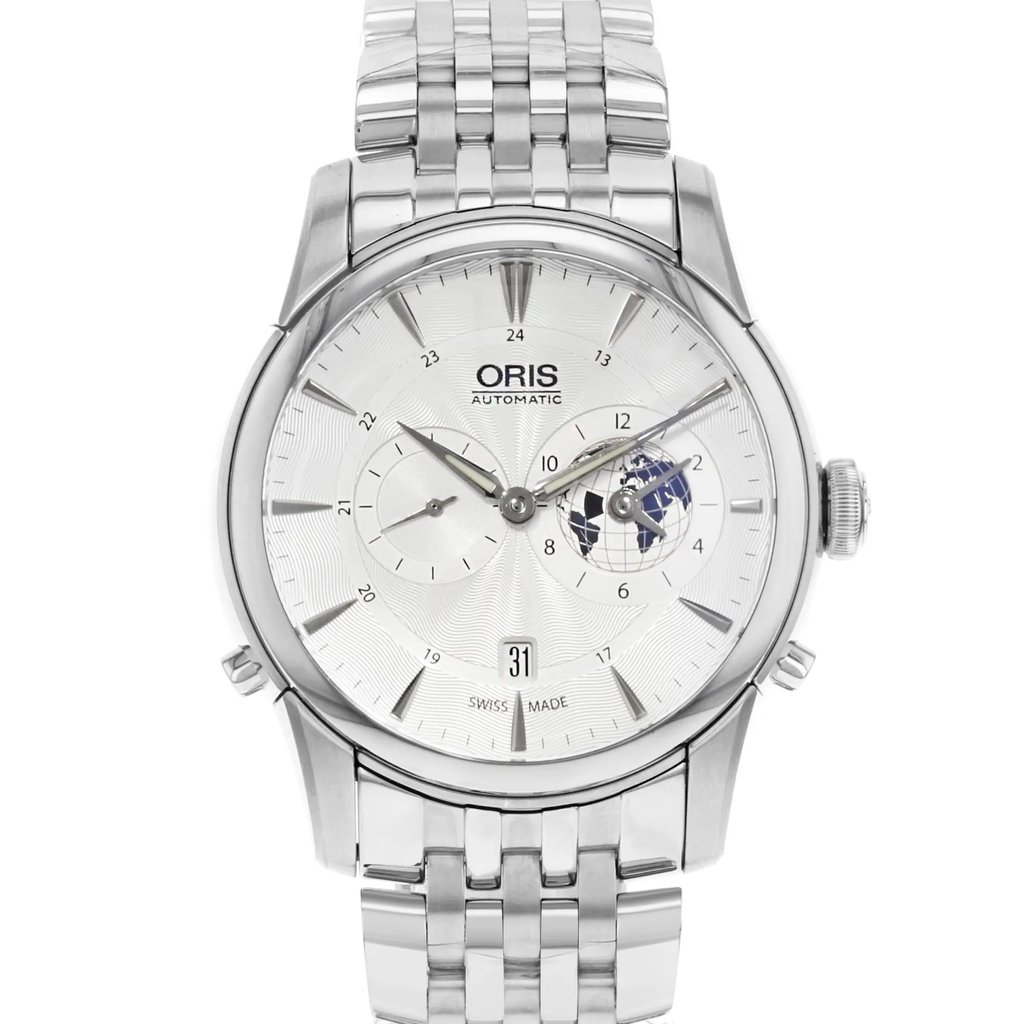 An image of a wristwatch showing a front close-up shot of the watch face. The watch is a display model with a polished metal bracelet and intricate dials, including a world map design. The brand name "Oris" is visible on the face, and the time is set against a textured silver background with a date display at the bottom. The angle captures the details clearly, highlighting the craftsmanship.