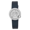 An image of a pre-owned Cartier Ballon Blanc De Cartier 26MM Diamonds Silver Dial Quartz Watch W4BL0002 positioned centrally and viewed from a top-down angle. The watch features a round face with a silver dial, surrounded by a bezel adorned with small diamonds. The time is indicated by Roman numerals and sleek hands. The watch is attached to a dark, smooth strap, and the image is captured at a close distance, highlighting the intricate details of the timepiece.