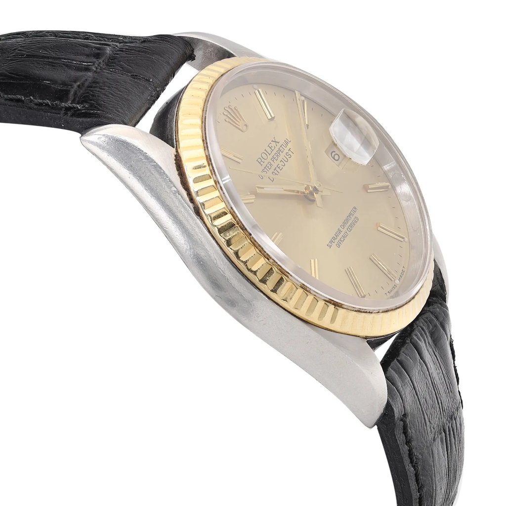 An image of a pre-owned men's Rolex wristwatch featuring a date indicator and luminous hands. The watch is displayed at a close angle, focusing on the right side of the case. The steel and gold tones of the case and bezel are highlighted, along with the black textured strap. The timepiece is positioned slightly tilted, emphasizing its elegant design and craftsmanship.