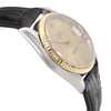 An image of a pre-owned men's Rolex wristwatch featuring a date indicator and luminous hands. The watch is displayed at a close angle, focusing on the right side of the case. The steel and gold tones of the case and bezel are highlighted, along with the black textured strap. The timepiece is positioned slightly tilted, emphasizing its elegant design and craftsmanship.