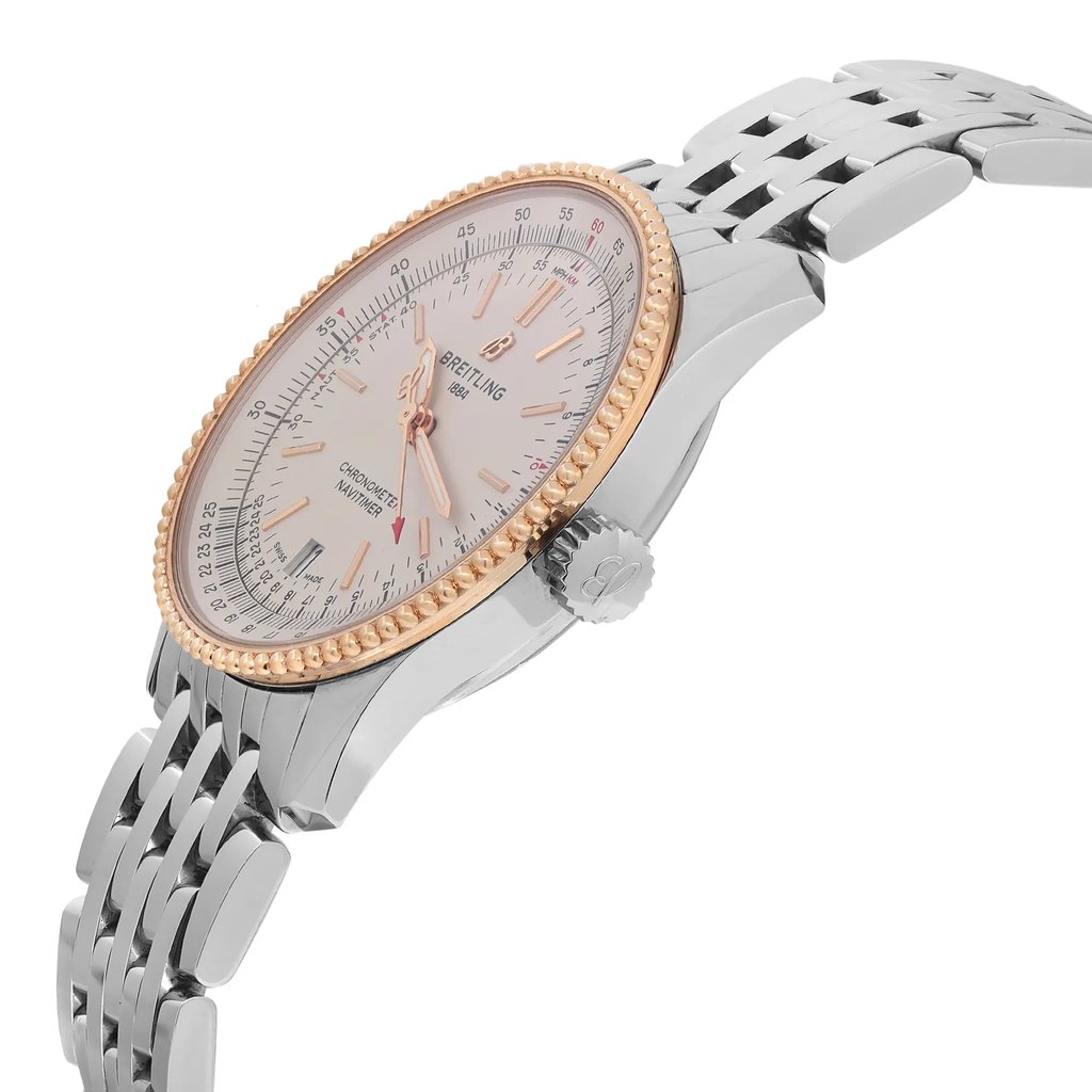 An image of a pre-owned Breitling men's wristwatch, presented in a side profile view with the crown visible. The watch features a round shape with a luxurious silver dial and a rose gold bezel. It is constructed from stainless steel for both the band and the case. Minor signs of wear are visible. The watch is equipped with a date indicator and luminous hands. The image is taken at a close distance, highlighting the watch's side angle and details.