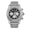 An image of a pre-owned Breitling men's luxury wristwatch, presented in a full frontal view. The watch features a round stainless steel case and band, with a black dial and gray bezel. The condition is good with light signs of wear. It has stick indexes, a date indicator, GMT, luminous hands, and a small seconds subdial. The watch is shown from a front angle, centered and occupying most of the image, making all details clearly visible.
