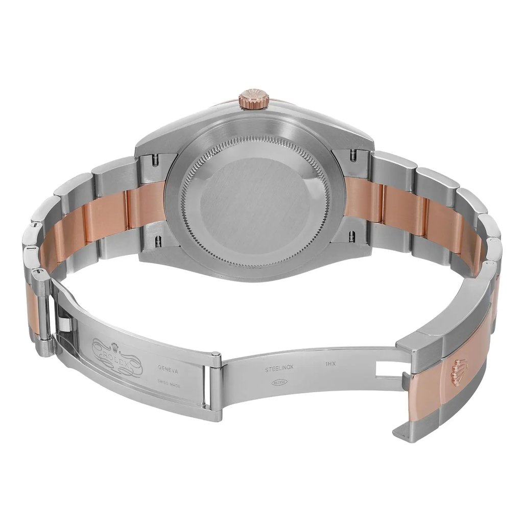 An image of a pre-owned men's Rolex wristwatch, featuring a stainless steel and rose gold bracelet. The watch is positioned horizontally with the back case and open clasp facing the viewer, providing a clear view of the metal links and engravings. The angle is slightly elevated, capturing details of the clasp and bracelet from a medium distance.
