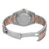 An image of a pre-owned men's Rolex wristwatch, featuring a stainless steel and rose gold bracelet. The watch is positioned horizontally with the back case and open clasp facing the viewer, providing a clear view of the metal links and engravings. The angle is slightly elevated, capturing details of the clasp and bracelet from a medium distance.
