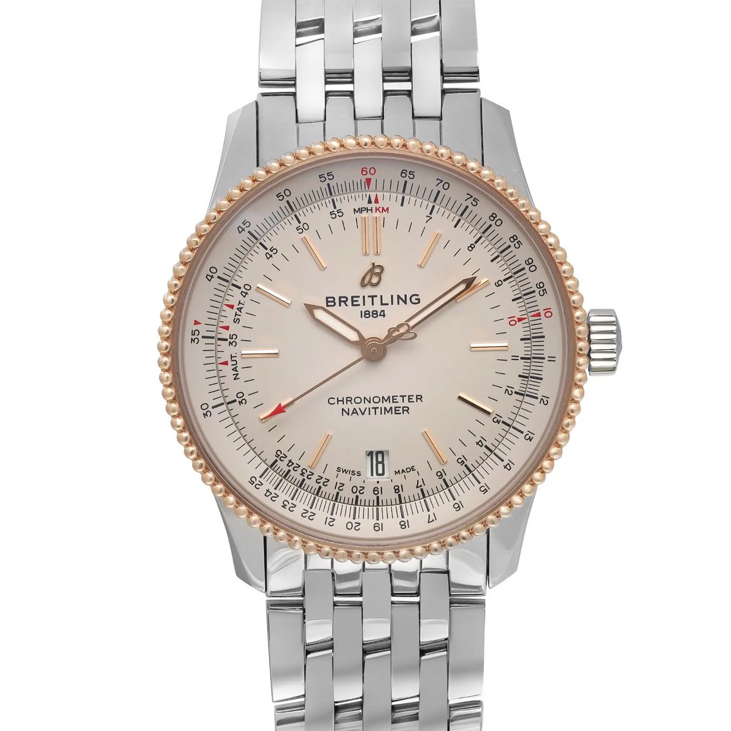 An image of a pre-owned Breitling men's wristwatch in excellent condition, presented in a full frontal view on a uniform background. The luxury watch features a round stainless steel case with a rose gold bezel, complemented by a silver dial with stick indexes and luminous hands. It has a date indicator at the 6 o'clock position and is affixed to a stainless steel band. The watch is captured from a direct front angle and close distance, showcasing minor signs of wear.