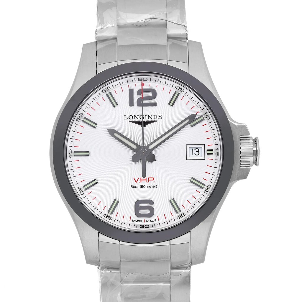 An image of a new wristwatch taken from a front close-up angle, highlighting the watch face. The watch features a metallic band, a white dial with black and red markers, and a date display. The brand name is visible near the top of the face.