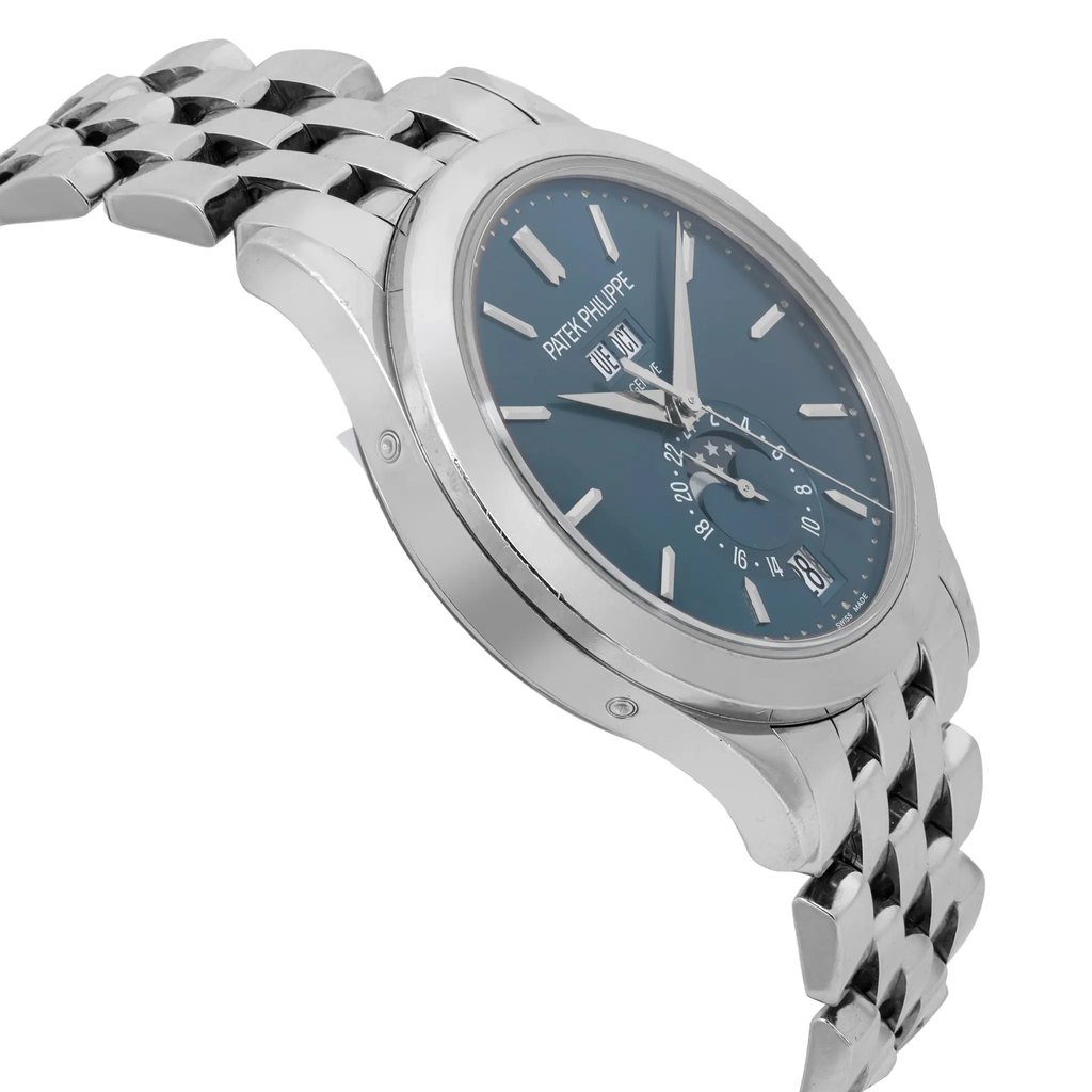 An image of a pre-owned men's Patek Philippe wristwatch viewed from a slight angle, showcasing its elegant design. The watch features a white gold bracelet and a dark dial with a date indicator and moon phase. The angle highlights the side profile and the face of the watch, captured from a close distance.