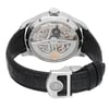 An image of a pre-owned wristwatch shown from the back view with an open clasp. The angle highlights the intricate mechanical details of the watch's movement. The watch features a black leather strap with a clasp that displays a circular emblem. The photograph is taken at a close distance, capturing the polished metal case and detailed craftsmanship.