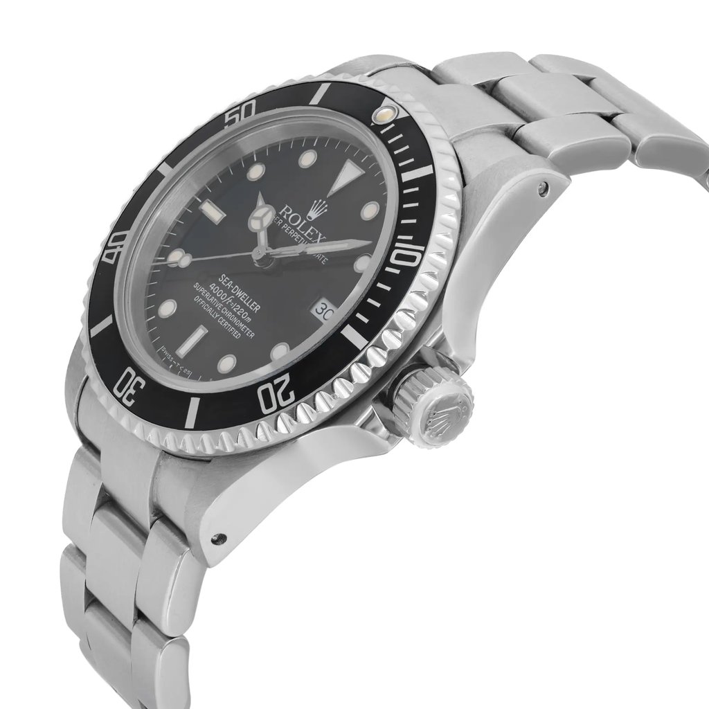 An image of a pre-owned men's Rolex diver wristwatch viewed from the side profile, showing the crown prominently. The watch features a round black dial with a matching black bezel. It has a stainless steel band and case. Notable features include a date indicator and luminous hands. The watch is positioned at an angle that highlights its sleek design and craftsmanship, captured from a close distance.