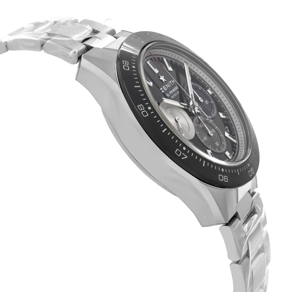 An image of a wristwatch captured from a side profile view, opposite the crown. The angle highlights the sleek, unworn condition of the watch, focusing on the detailed design of the face and the metallic band. The watch is positioned at a slight angle, allowing for a clear view of the watch's thickness and the intricate markings on the bezel, all captured from a close distance.