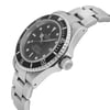 An image of a pre-owned men's Rolex luxury wristwatch viewed from the side profile, showcasing the crown prominently. The watch features a round shape with a black dial and bezel, and is made of stainless steel, indicating good condition. The band is also stainless steel. Notable features include a date indicator and luminous hands.