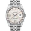 An image of a pre-owned women's Rolex wristwatch, viewed from the front at a close distance. The watch features a round face with a silver floral pattern, surrounded by a diamond-studded bezel. The dial displays the date indicator at the 3 o'clock position and has luminous hands. The stainless steel bracelet is partially visible at the top and bottom of the image.
