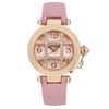 An image of a pre-owned Cartier Pasha De 32mm women's rose gold grille silver dial wristwatch taken from a front-facing angle. The watch features a round rose gold case with a prominent crown on the right side. The dial includes a date indicator and is adorned with sparkling embellishments around the numeral markers. The watch has a pink leather strap, and the image is captured at a close-up distance to highlight the intricate details.