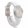 An image of a pre-owned Audemars Piguet women's wristwatch. The watch is positioned at a slight angle, showcasing the face and part of the strap. The silver watch face features Roman numerals and a small subdial, encircled by a band of sparkling diamonds. The white strap is partially visible, with the watch standing upright and slightly turned to the right. The photo is taken from a close distance, capturing the intricate details of the watch design.