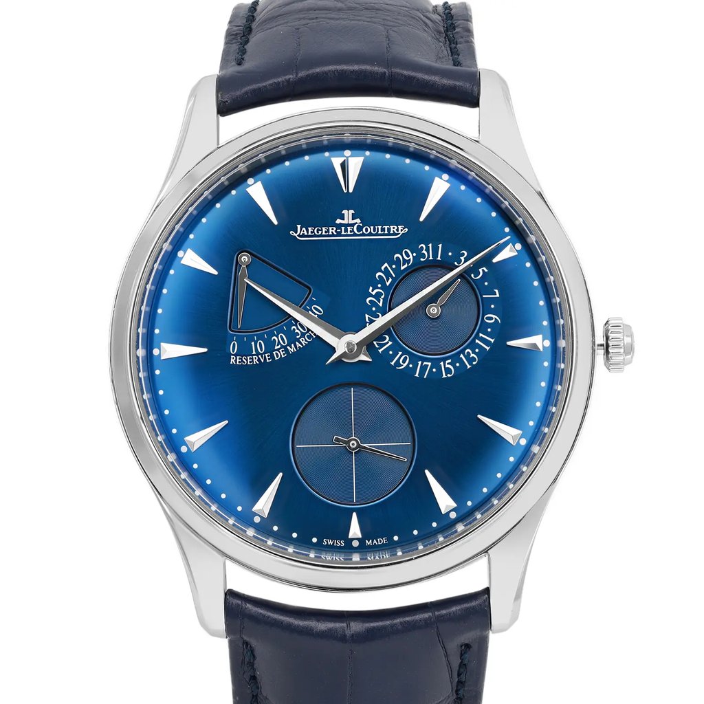 An image of a pre-owned wristwatch featuring a front close-up shot of the watch face. The watch has a blue dial with silver hour markers and hands. It includes a power reserve indicator and a date subdial. The watch case is silver, and the strap is dark leather. The brand name is displayed prominently below the 12 o'clock position.