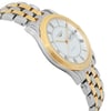 An image of a pre-owned Longines men's wristwatch in a dress/formal style. The image shows a side profile view from the opposite side of the crown, positioned at a slight angle to highlight the round shape of the watch face and the stainless steel band. The dial color is white, set within a gold-tone bezel, and the band features a combination of stainless steel and gold-tone links. The watch has micro scratches on the gold-tone parts, indicating its pre-owned condition. The watch appears to be a medium distance from the camera, providing a clear view of the details.