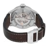 An image of a pre-owned IWC Timezoner Le Petit Prince Edition men's wristwatch viewed from the back at a slight angle, showcasing the intricate mechanism through the transparent case back. The watch features a silver metal case, a dark brown leather strap with white stitching, and a metal clasp engraved with "IWC." The image is taken at a close distance, highlighting the detailed craftsmanship and the watch's luminous hands feature.