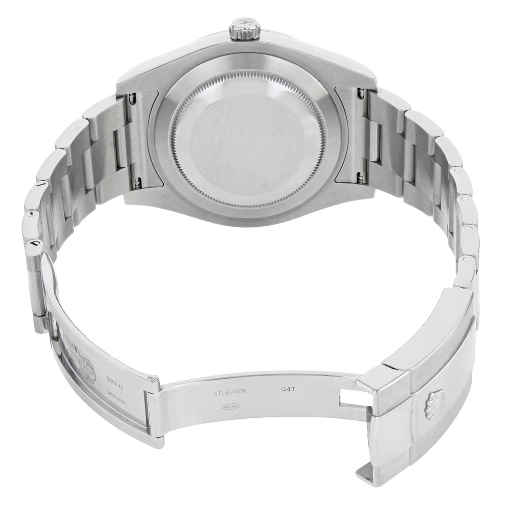 An image of a pre-owned wristwatch captured from the back view. The watch is positioned at a slight angle, showing the open clasp and the inner side of the metal bracelet. The distance is close enough to reveal details like the engravings on the clasp. The watch case and bracelet are metallic, and the focus is on the back casing and clasp mechanism.