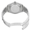 An image of a pre-owned wristwatch captured from the back view. The watch is positioned at a slight angle, showing the open clasp and the inner side of the metal bracelet. The distance is close enough to reveal details like the engravings on the clasp. The watch case and bracelet are metallic, and the focus is on the back casing and clasp mechanism.