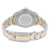An image of a pre-owned wristwatch taken from the back view, showing the closed clasp. The watch features a two-tone metal band with silver and gold elements. The angle captures the watch's back case prominently, with the crown visible at the top. The image is taken at a close distance, highlighting the details of the clasp and the bracelet links.