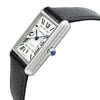 An image of a Cartier men's casual wristwatch, showcasing a side profile view with the crown visible. The watch has a stainless steel rectangular case with a silver dial and gray bezel, complemented by a black leather band. The crown is adorned with a blue cabochon, and the image is taken from a close distance, focusing on the watch at a slight angle to display the watch's side and crown details. The watch is display model condition and may show light blemishes due to store handling.