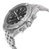 An image of a pre-owned Breitling men's wristwatch in a pilot/aviator style. The photo shows a side profile view of the watch, with the crown and two push-buttons prominently displayed. The watch features a round stainless steel case and a matching stainless steel band. It has a black dial with white markings and a gray bezel. The watch is positioned at a slight angle, with the watch face visible and the band extending into the background, giving a clear view of the watch's design and features. The images show minor patina on the hour markers and light scratches on the bezel.