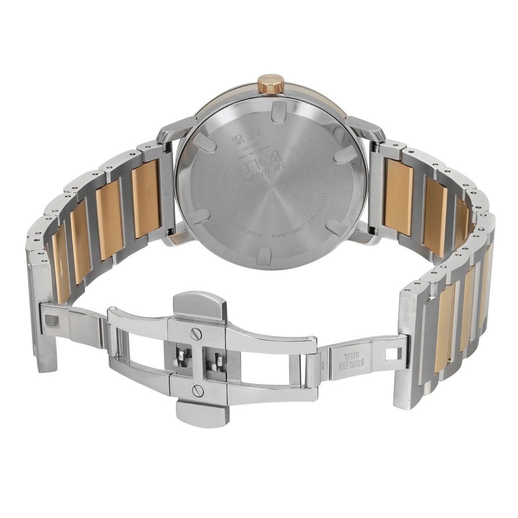 An image of a pre-owned wristwatch taken from the back view at a close distance. The watch's clasp is open, revealing a two-tone metal bracelet with alternating silver and gold links. The case back is round and metallic, with engraved text. The angle shows the watch lying flat with the open clasp facing forward, highlighting the details of the bracelet and clasp mechanism.