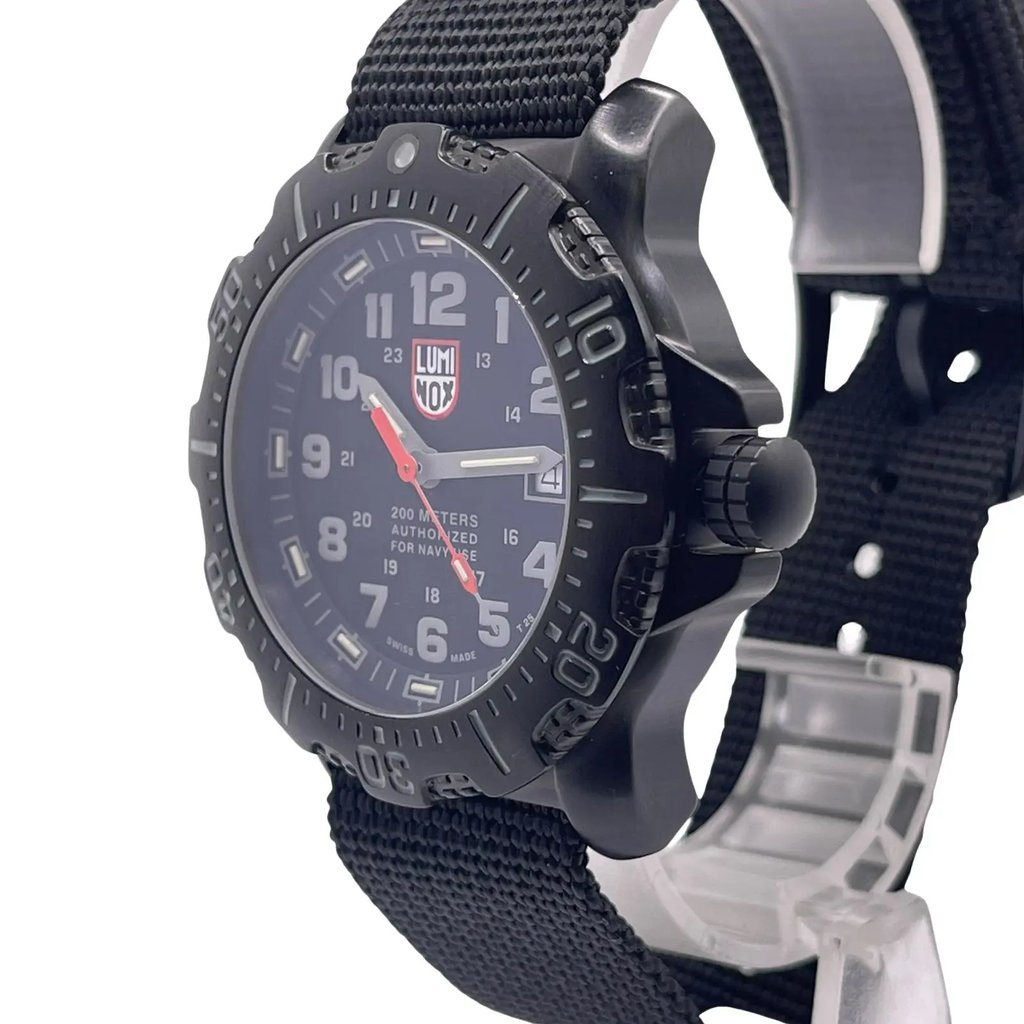 An image of a Wristwatch by Luminox. This Display Model item is designed for Men, featuring a Casual,Diver style. It has a Quartz movement and an Analog display with a Black dial color. The indices include 12-Hour Dial,Arabic Numerals,Easy to Read/Large Numerals. The band is made of Nylon and the case is made of Stainless Steel. The watch has a Round shape with a case size of 45 mm and a case thickness of 15 mm.