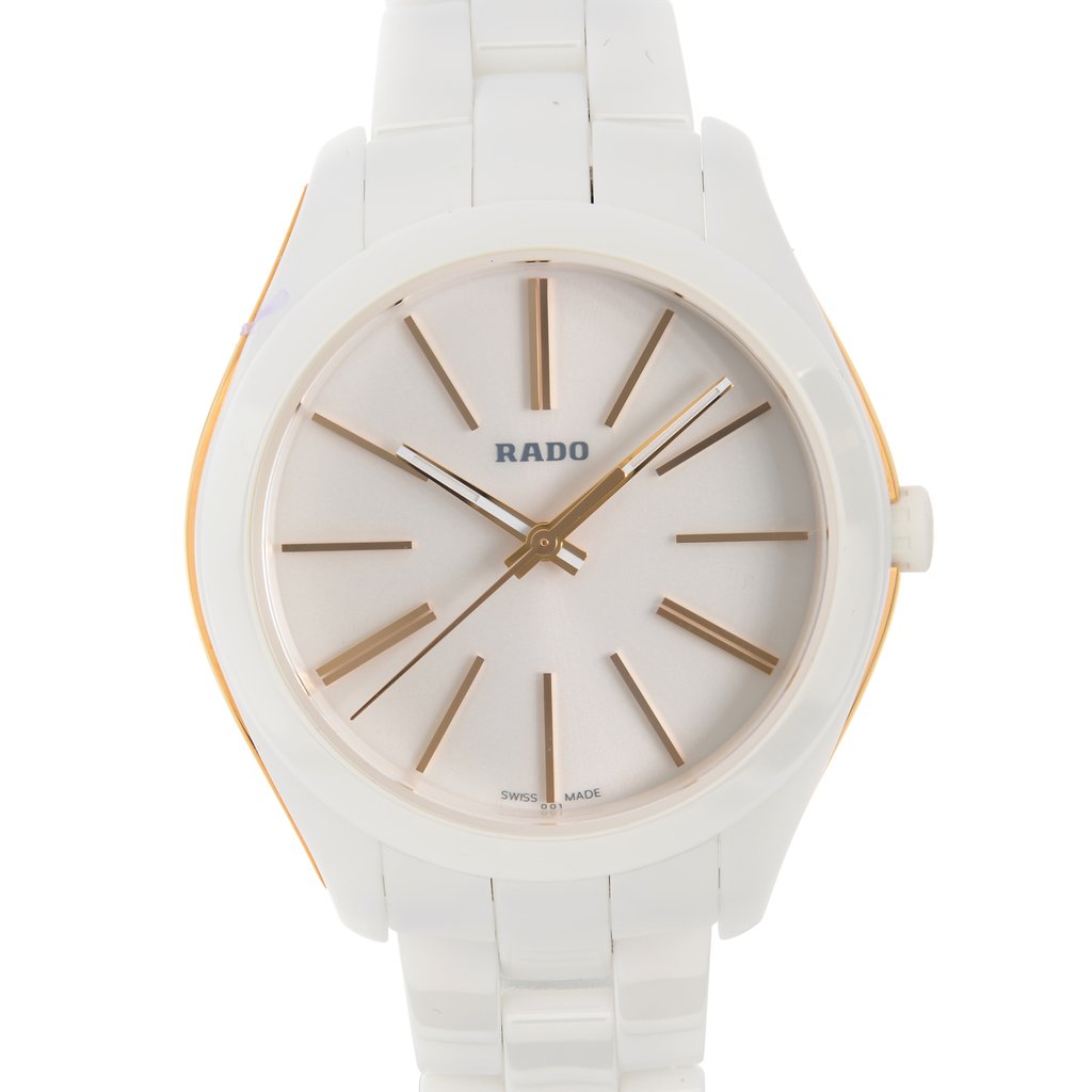 An image of a wristwatch taken from a front close-up perspective, highlighting the watch face. The watch is a display model featuring a white strap and case. The dial is simple and elegant with gold hour markers and hands, and the brand name "RADO" is visible on the face.
