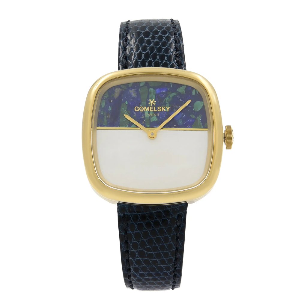 An image of a wristwatch shown from a front full frontal view, highlighting its unworn condition. The timepiece features a square gold-tone case with a unique dial design that combines a colorful upper half and a plain lower half. The brand name is visible at the top of the dial. The watch is paired with a textured black strap, positioned centrally and photographed from a close distance to capture its details clearly.