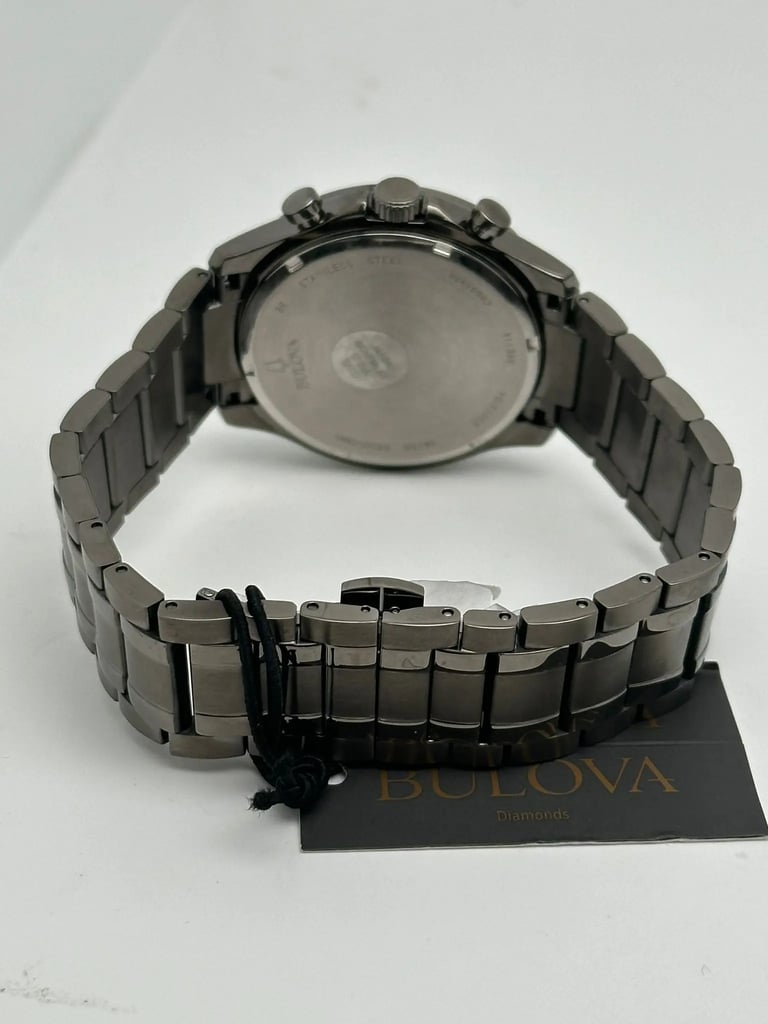 An image of a Wristwatch by Bulova. This Display Model item is designed for Men, featuring a Casual,Dress/Formal style. It has a Quartz movement and an Analog display with a Black dial color. The indices include 12-Hour Dial,Diamond Markers. The band is made of Stainless Steel and the case is made of Stainless Steel. The watch has a Round shape with a case size of 43 mm and a case thickness of 11 mm.
