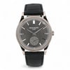 An image of a pre-owned Patek Philippe Calatrava 18K White Gold Gray Dial Men Watch 6119G-001 shown from a straight-on angle. The watch features a gray dial with silver hour markers, a small subdial, and sleek hands. It has a textured silver bezel and a black leather strap. The photograph captures the watch in close-up, highlighting its elegant design and intricate details. Pre-owned in excellent condition. Comes with Patek travel pouch and paper. No manuals just papers. Recently serviced. The movement is calibrated and keeps time well.