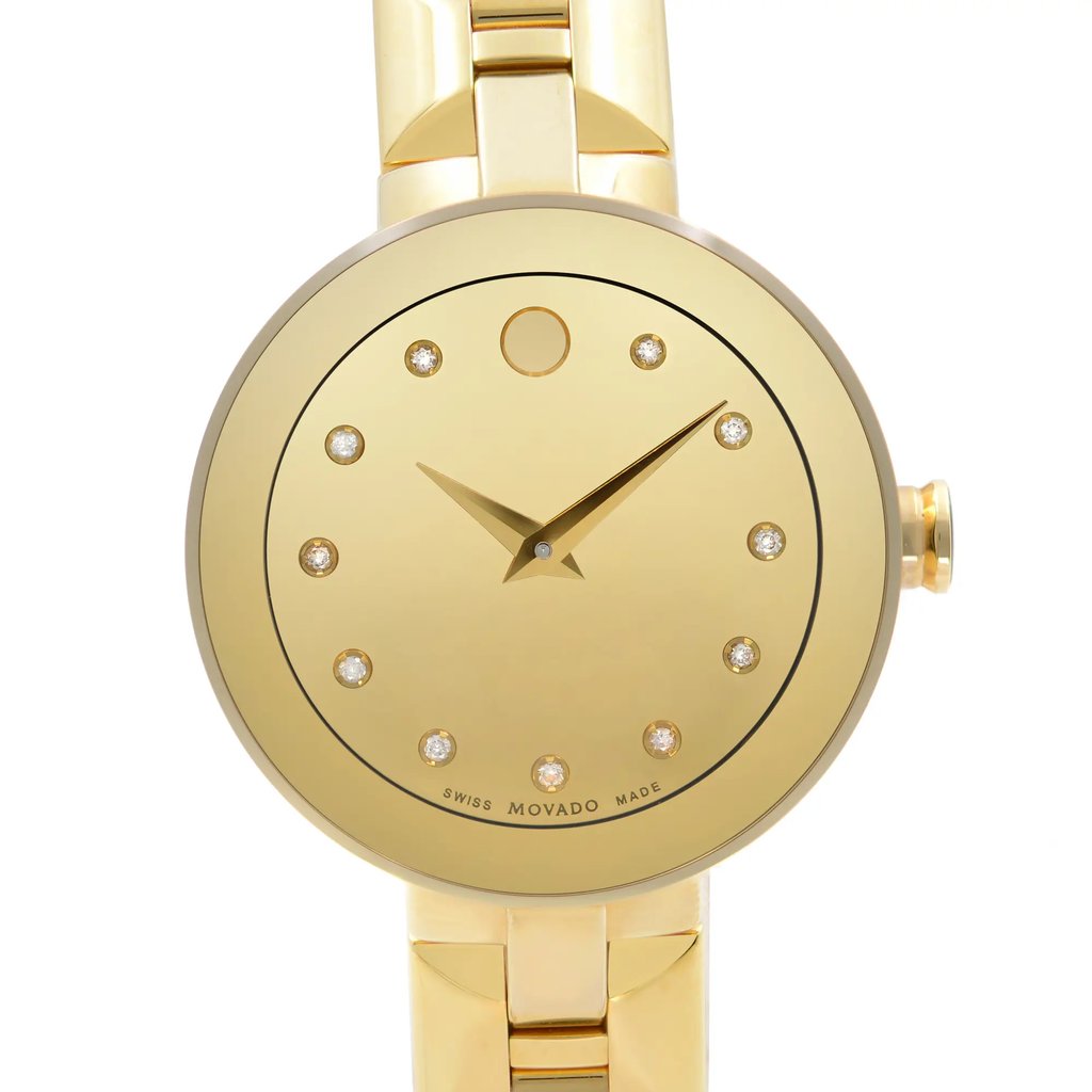 An image of a wristwatch taken from a front close-up angle, showcasing the watch face. The watch has a sleek gold design with minimalist hour markers and hands. The crown is visible on the right side, and the watch is connected to a matching gold bracelet. The watch face is reflective and polished, emphasizing its display model condition.