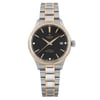 An image of a wristwatch taken from a front full-frontal view. The watch is unworn and features a dual-tone metal bracelet with gold and silver links. The black dial has gold hour markers and hands, with a date display at the 3 o'clock position. The brand name is visible at the top of the dial. The watch is positioned centrally against a plain background, captured at a close distance to highlight its details.
