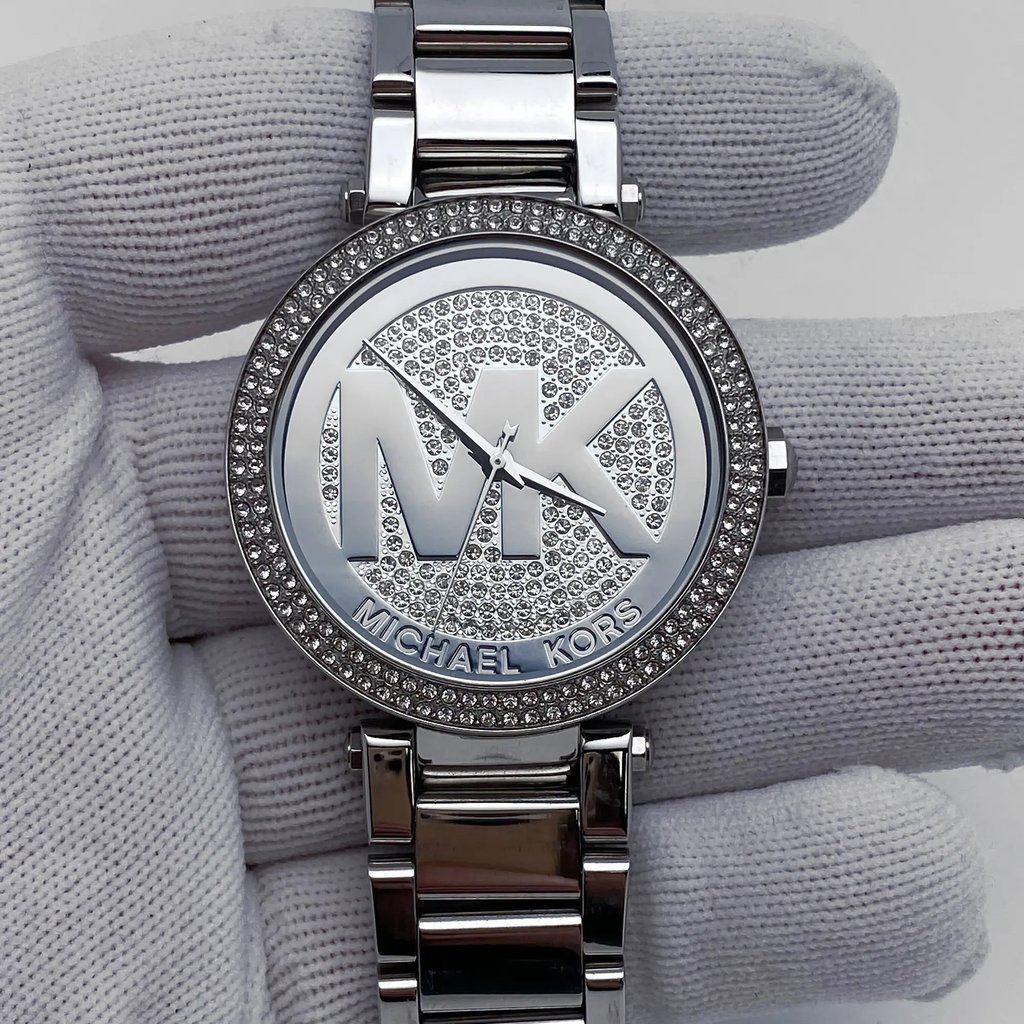 An image of a Wristwatch by Michael Kors. This Pre Owned item is designed for Women, featuring a Casual,Classic,Dress/Formal,Luxury style. It has a Quartz movement and an Analog display with a Silver dial color. The indices include No Hour Marks. The band is made of Stainless Steel and the case is made of Stainless Steel. The watch has a Round shape with a case size of 39 mm and a case thickness of 11 mm.