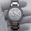An image of a Wristwatch by Michael Kors. This Pre Owned item is designed for Women, featuring a Casual,Classic,Dress/Formal,Luxury style. It has a Quartz movement and an Analog display with a Silver dial color. The indices include No Hour Marks. The band is made of Stainless Steel and the case is made of Stainless Steel. The watch has a Round shape with a case size of 39 mm and a case thickness of 11 mm.