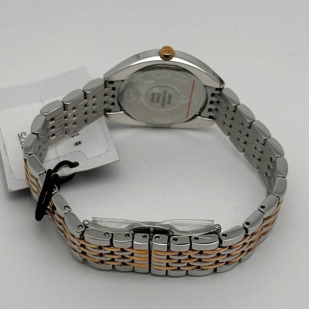 An image of a Wristwatch by Bulova . This New With Defects item is designed for Women, featuring a Casual,Dress/Formal style. It has a Quartz movement and an Analog display with a Rose Gold-Tone dial color. The indices include 12-Hour Dial,Diamond Markers,Roman Numerals,Stick Indexes. The band is made of Stainless Steel and the case is made of Stainless Steel. The watch has a Tonneau/Barrel shape with a case size of 30 mm and a case thickness of 8 mm.