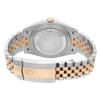 An image of a pre-owned Rolex men's wristwatch in good condition, showing light signs of wear or scratches. The photo presents a close-up back view of the watch, focusing on the screwback case back made of stainless steel and the fold-over clasp. The round-shaped case is attached to a two-tone band combining rose gold and stainless steel links. The clasp is centered and detailed with the Rolex crown logo. The watch is positioned horizontally with the clasp closed and the band slightly tapering off towards the top and bottom edges of the frame, suggesting a natural wrist-like curve.