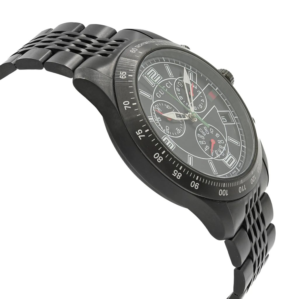 An image of a pre-owned Gucci men's wristwatch in a dress/formal style, shown in a side profile view opposite the crown. The watch is positioned at a slight angle to display its round shape, black dial, and black bezel. It features a stainless steel band and case, with chronograph functions, luminous hands, and a small seconds subdial. The photo is taken from a close distance, focusing on the watch's details.