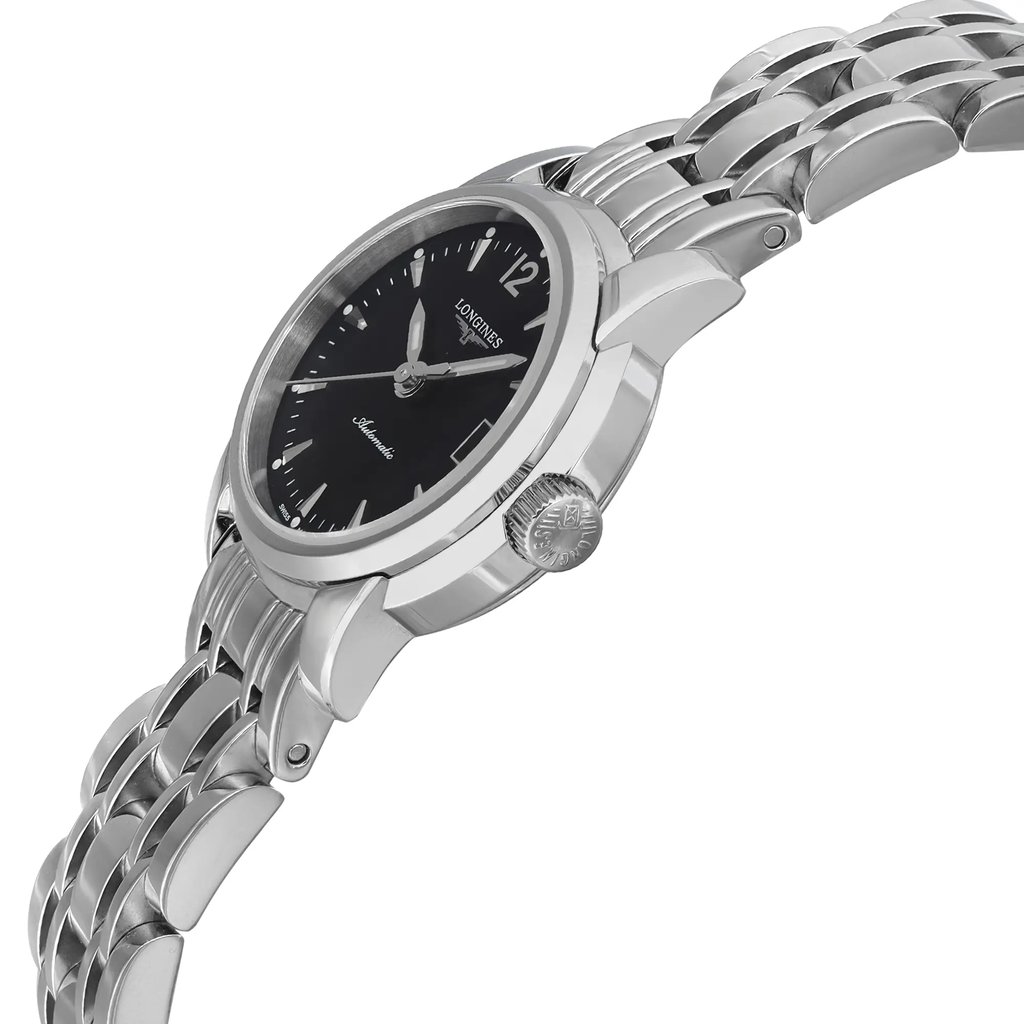 An image of a pre-owned wristwatch shown from a side profile view, highlighting the crown. The watch features a black dial and a silver metal bracelet. The angle emphasizes the watch's thickness and the intricate design of the bracelet links. The distance is close enough to show details like the crown's texture and the brand name on the dial.