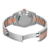 An image of a pre-owned Rolex wristwatch for men, viewed from the back with an open clasp. The watch is composed of stainless steel and rose gold materials and features a round shape with a screwback caseback showing a sticker. The fold-over clasp is partially unfolded, and the band exhibits minor signs of wear or scratches. The watch is positioned centrally with the caseback facing up, and the image is taken from a medium distance, capturing the entire back view of the watch.