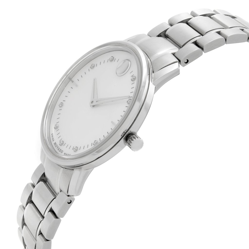 An image of a pre-owned wristwatch captured from a side profile view. The watch features a sleek design with a visible crown on the right side. The angle showcases the metallic bracelet and the minimalist watch face, emphasizing its clean and elegant aesthetic. The image is taken from a close distance, highlighting the details of the watch's construction.